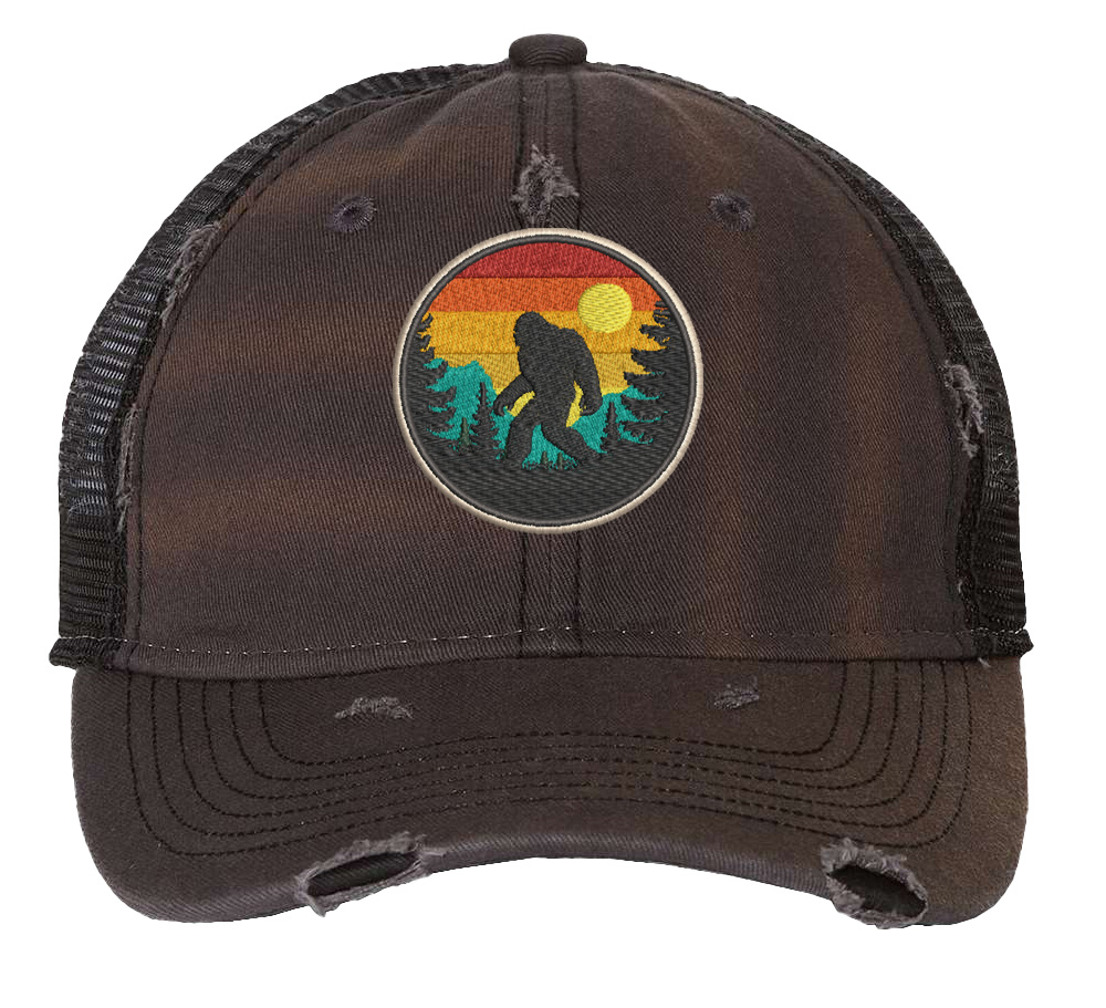 Distressed Bigfoot trucker hat with embroidered Sasquatch patch and mesh back panel for outdoor adventures